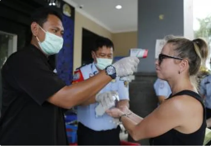 woman having temperature checked
