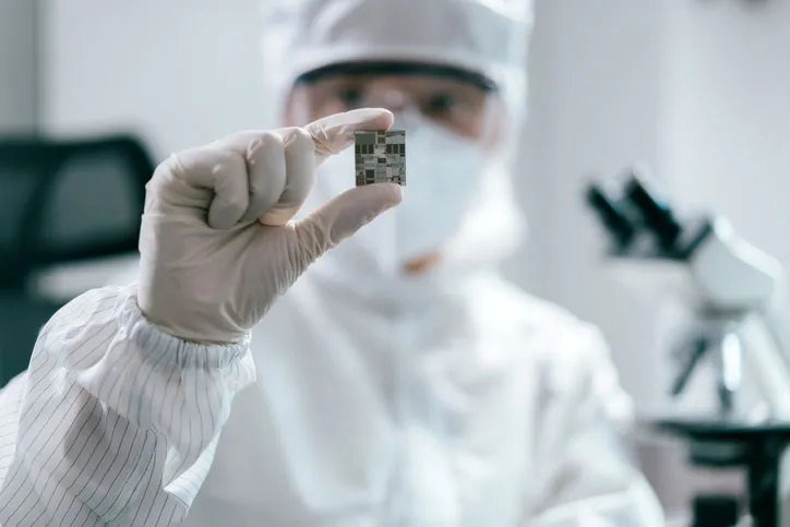 Chinese engineer inspecting wafer chip in laboratory