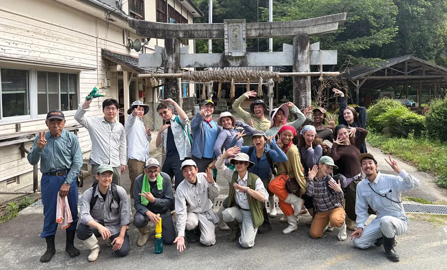 Columbia Summer in Itoshima participants in front of a torii gate at Sansonjuku, June 2026. 